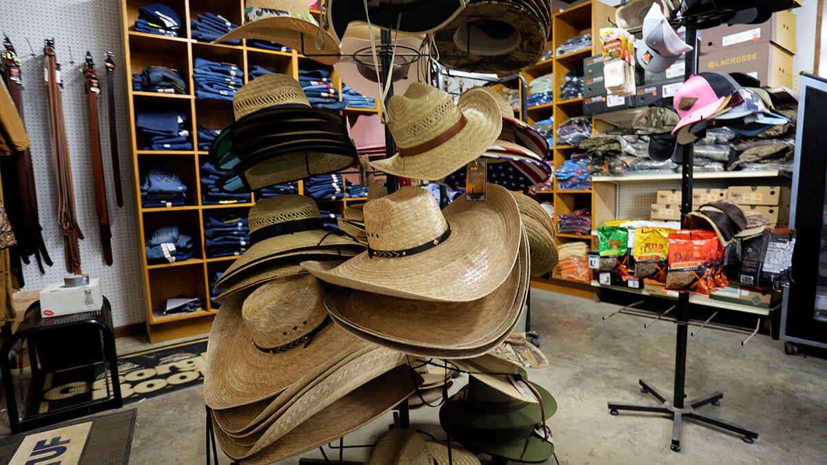 Display of straw cowboy hats and trucker caps